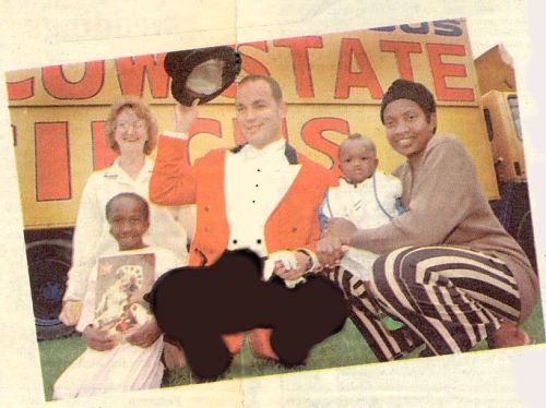 CIRCUS TREAT: Aminata with ringmaster Andrew Wadland, the event was a family day out and Aminata is pictured with Lorna Robinson, Mr Wadland, her seven-month-old sister Adama and mother Mama